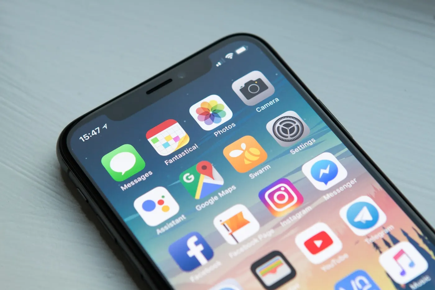Smartphone held over a soft workspace surface
